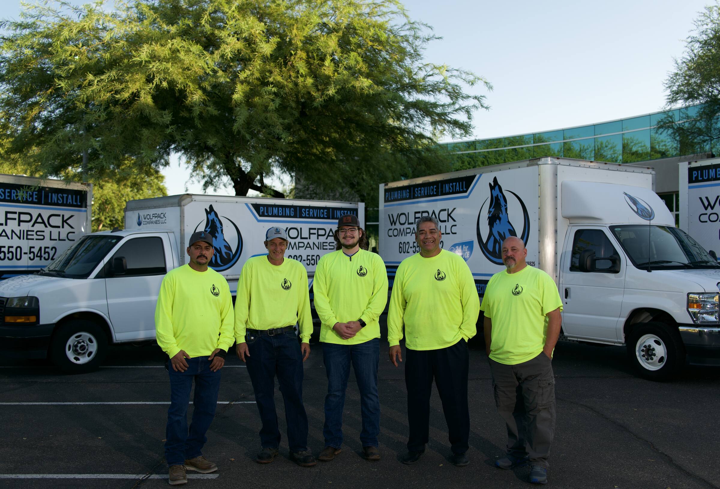 The Wolfpack Companies crew in front of their service trucks