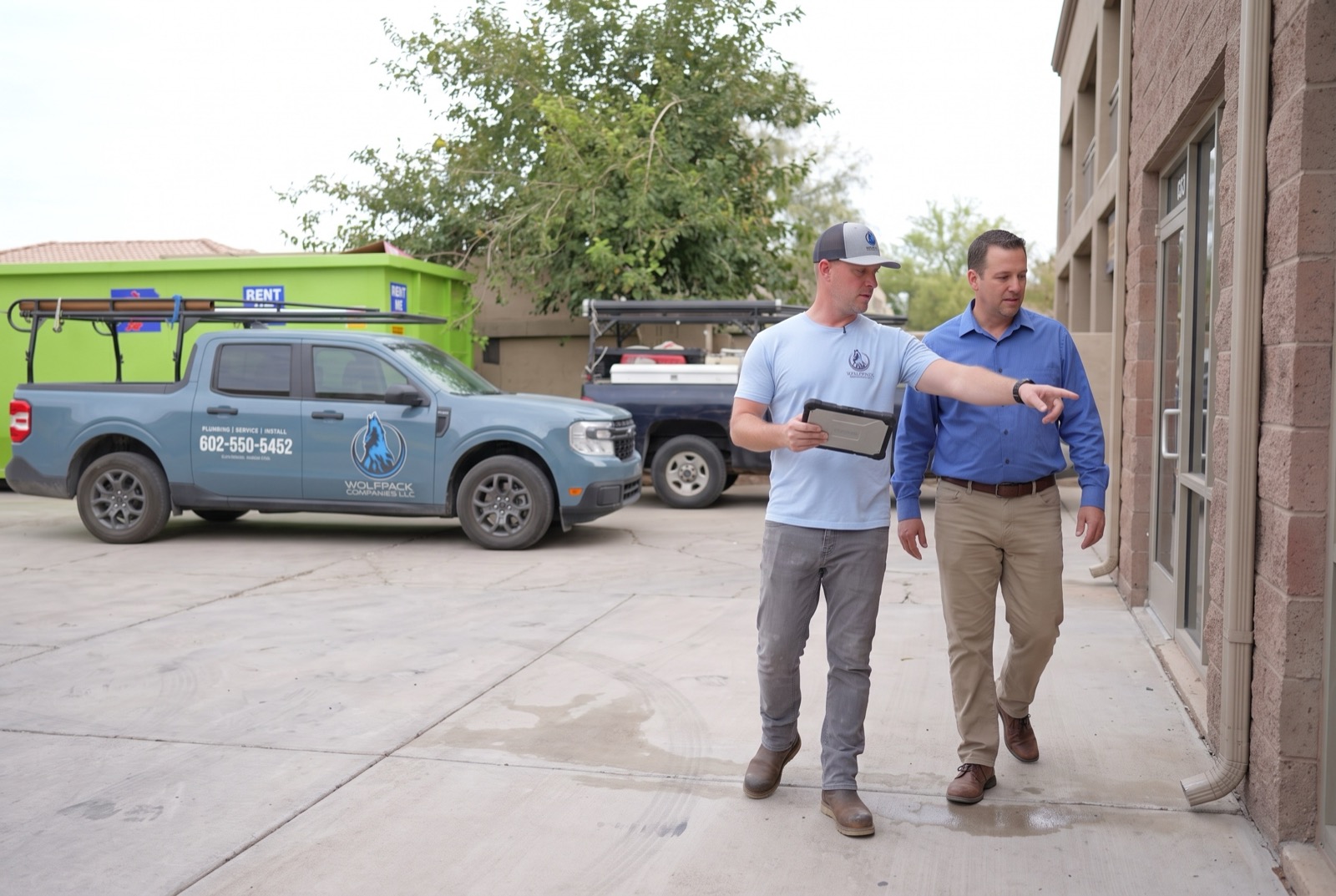 Wolfpack walking a property with a facility manager