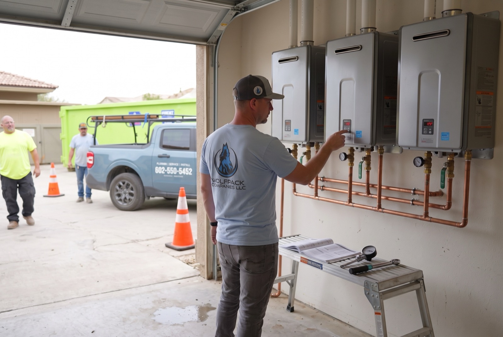 Technician commissioning a bank of three tankless water heaters