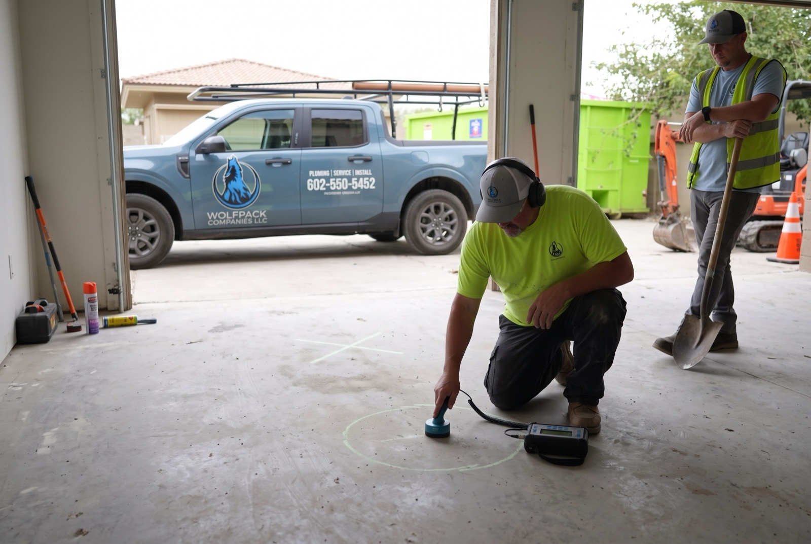 Technician sweeping a slab with acoustic leak detection equipment
